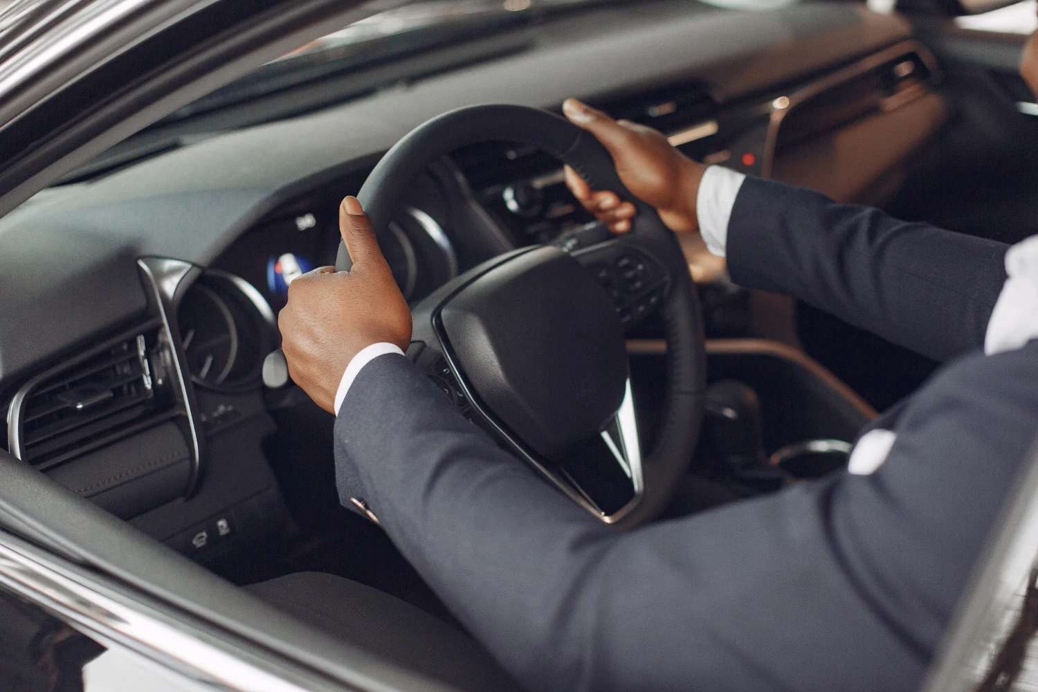 Professional driver with hands on the steering wheel